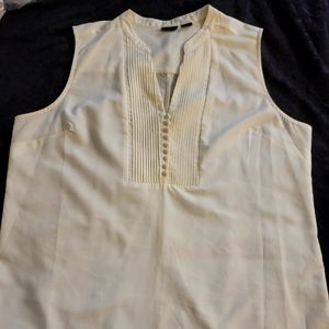 Sleeveless blouse with pleated neckline